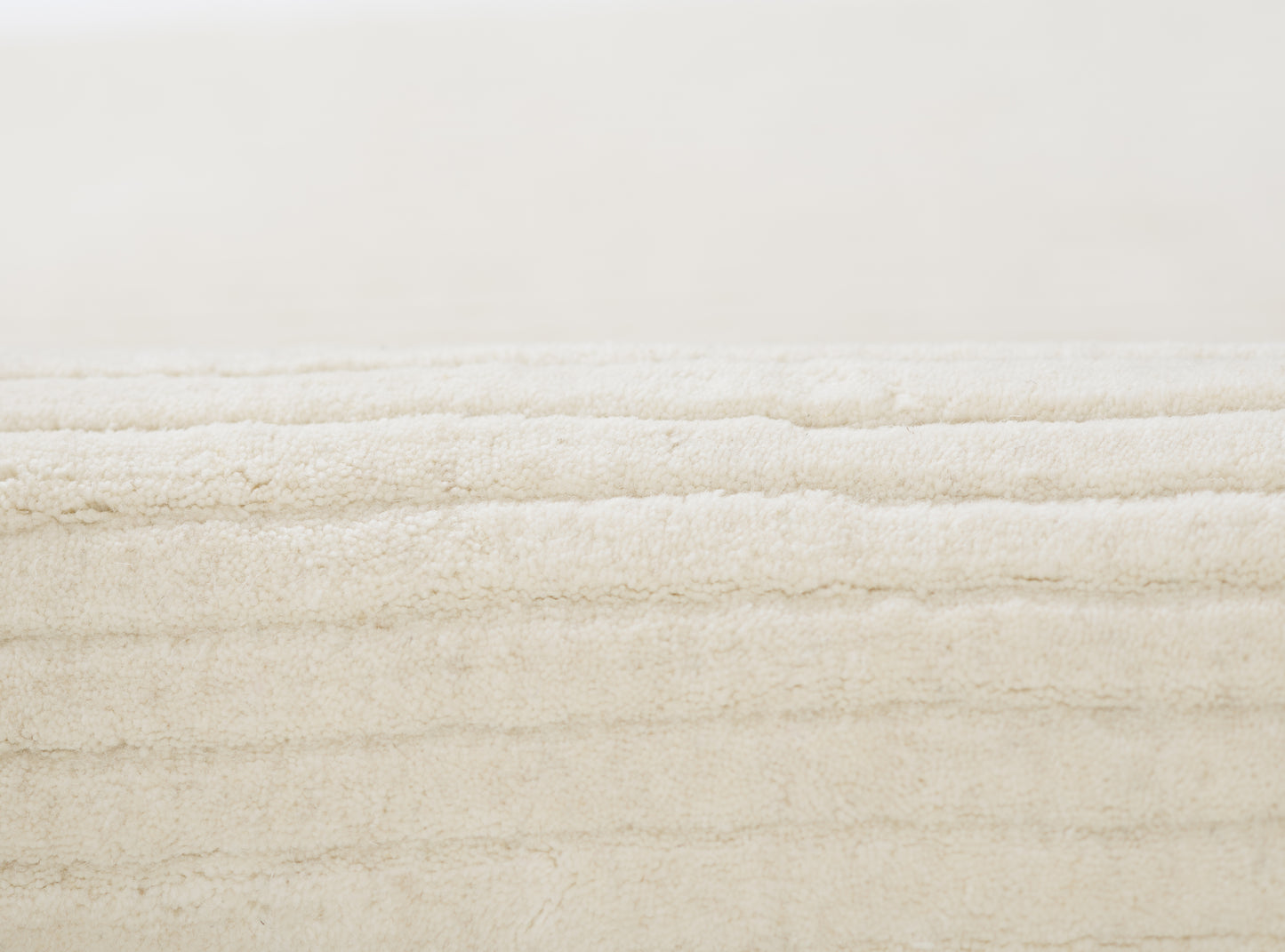 Creamy white plush rug runner with a soft, dense pile.