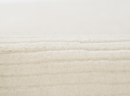 Cream rectangular plush shag rug with thick fluffy pile and cozy texture.