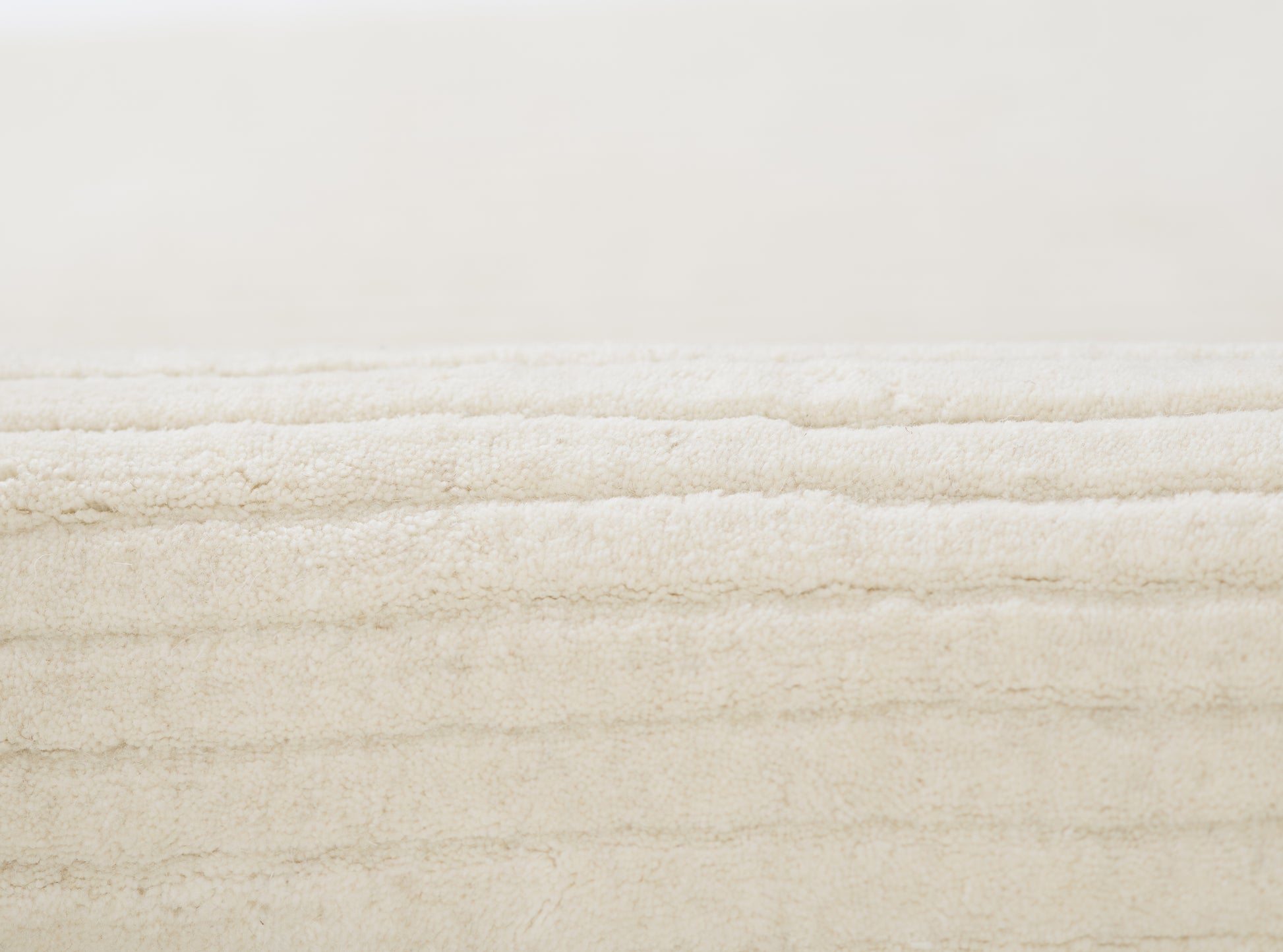 Cream plush fabric with dense, soft pile; cozy textured home decor accent.