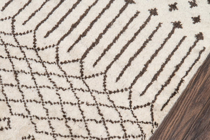 Beige rug with dark brown linear lattice stripes; modern geometric pattern on wood floor corner.
