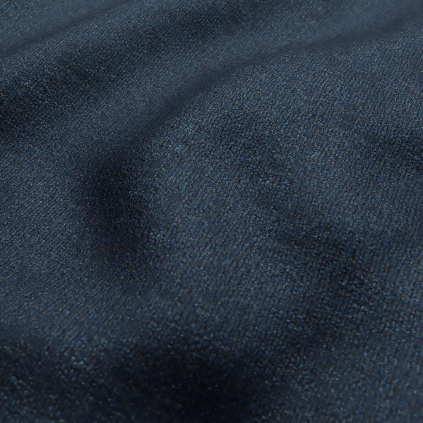 Close-up of dark blue boucle fabric texture with subtle creases.