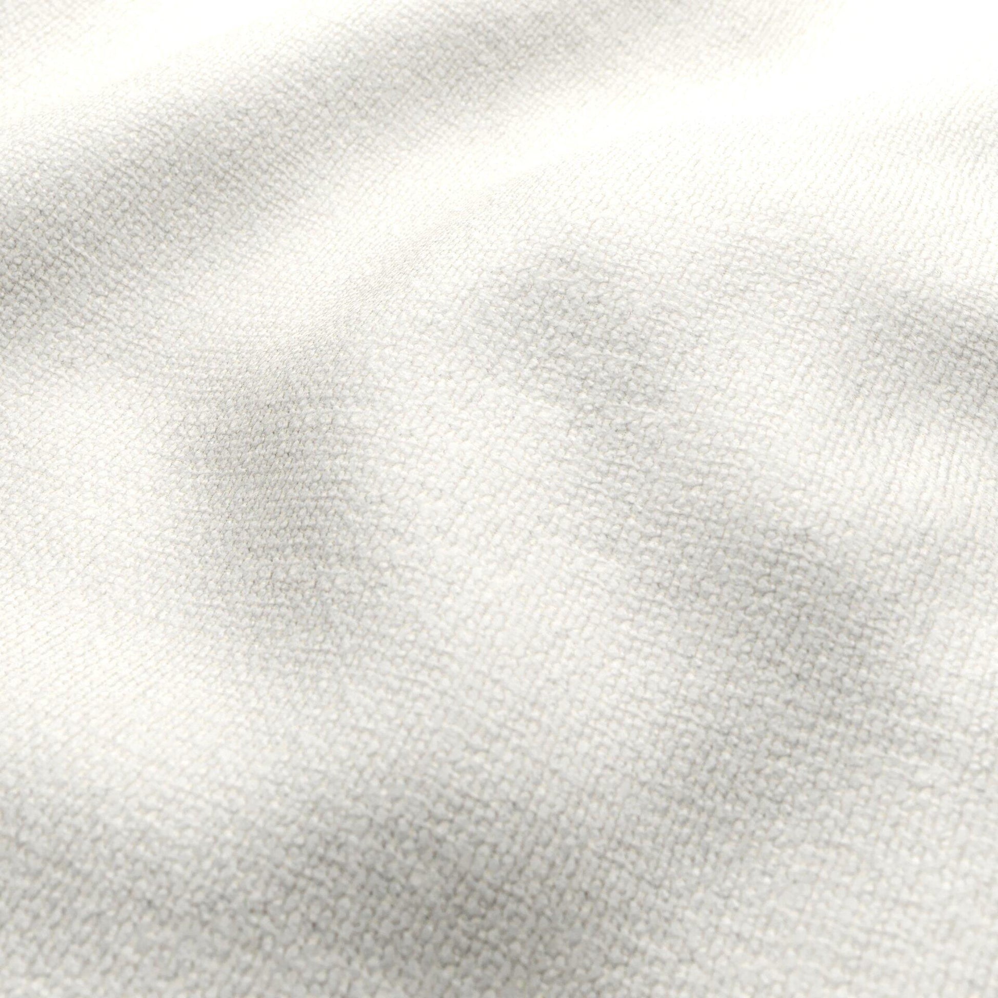 Cream boucle fabric close-up with soft folds; ivory-white textured textile.