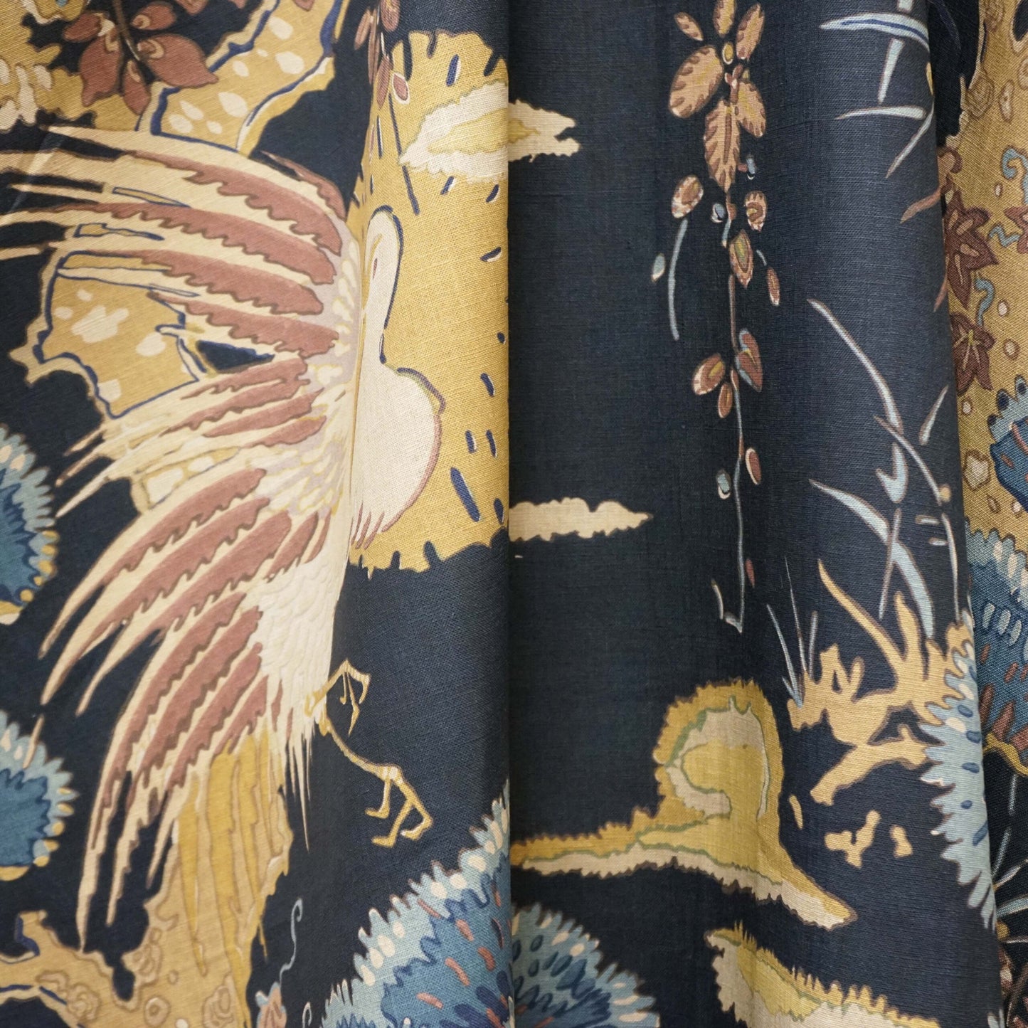 Navy fabric with a gold crane and pale blue floral print; tropical chinoiserie motif