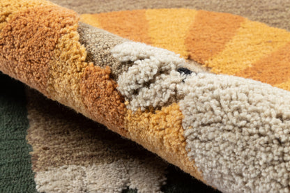 Patchwork shag area rug with olive green, mustard, tan and cream; thick plush pile, rolled edge.