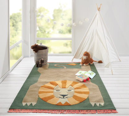 Beige lion rug with orange mane and green border; soft kids' play mat in a bright room with a teepee.