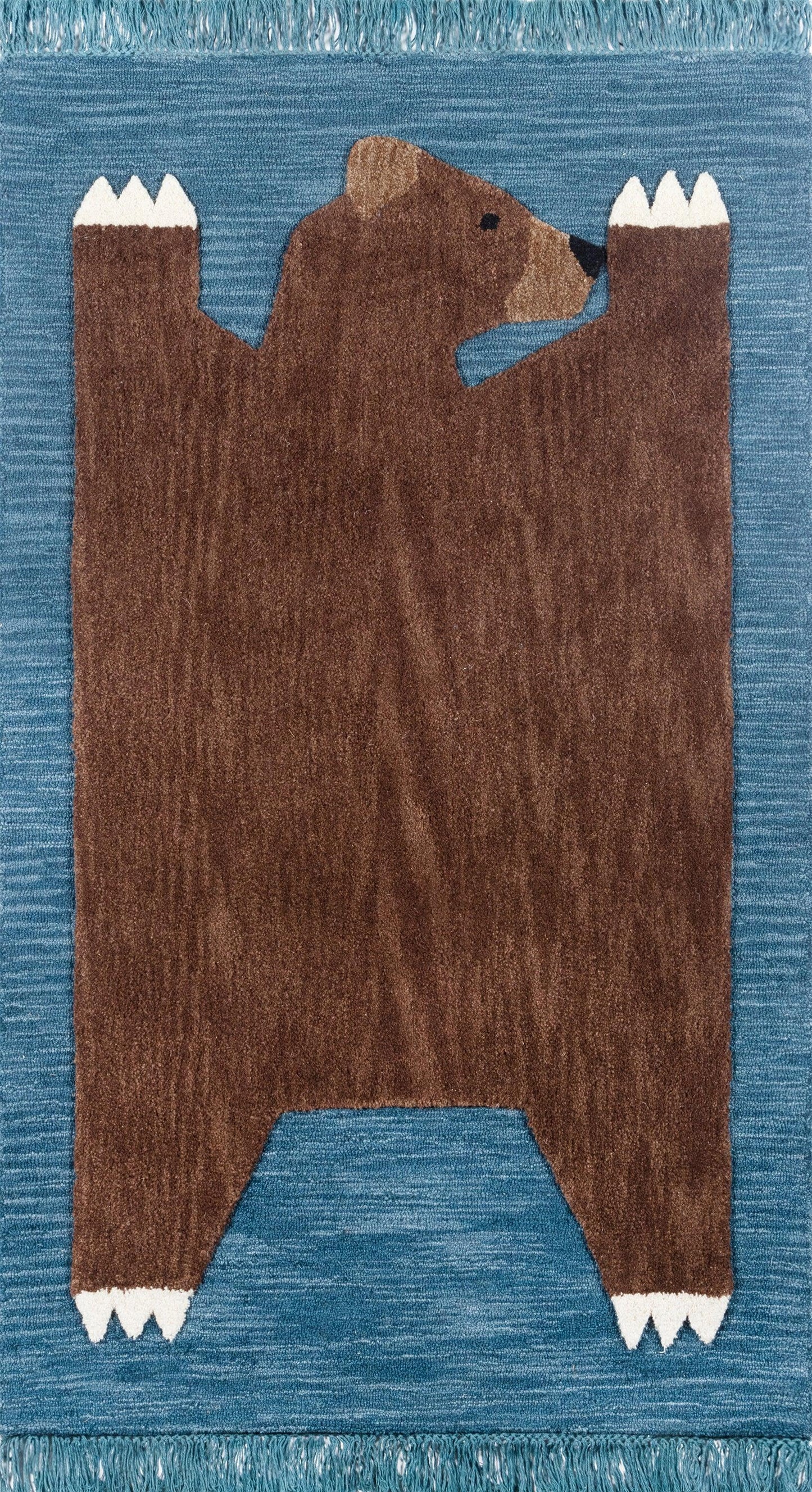 Blue woven rug featuring a large brown bear silhouette with white claw tips and fringed edges.