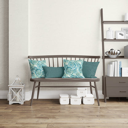 Dark brown metal-framed bench with wood seat and spindle back, teal and turquoise cushions in a cozy living room.