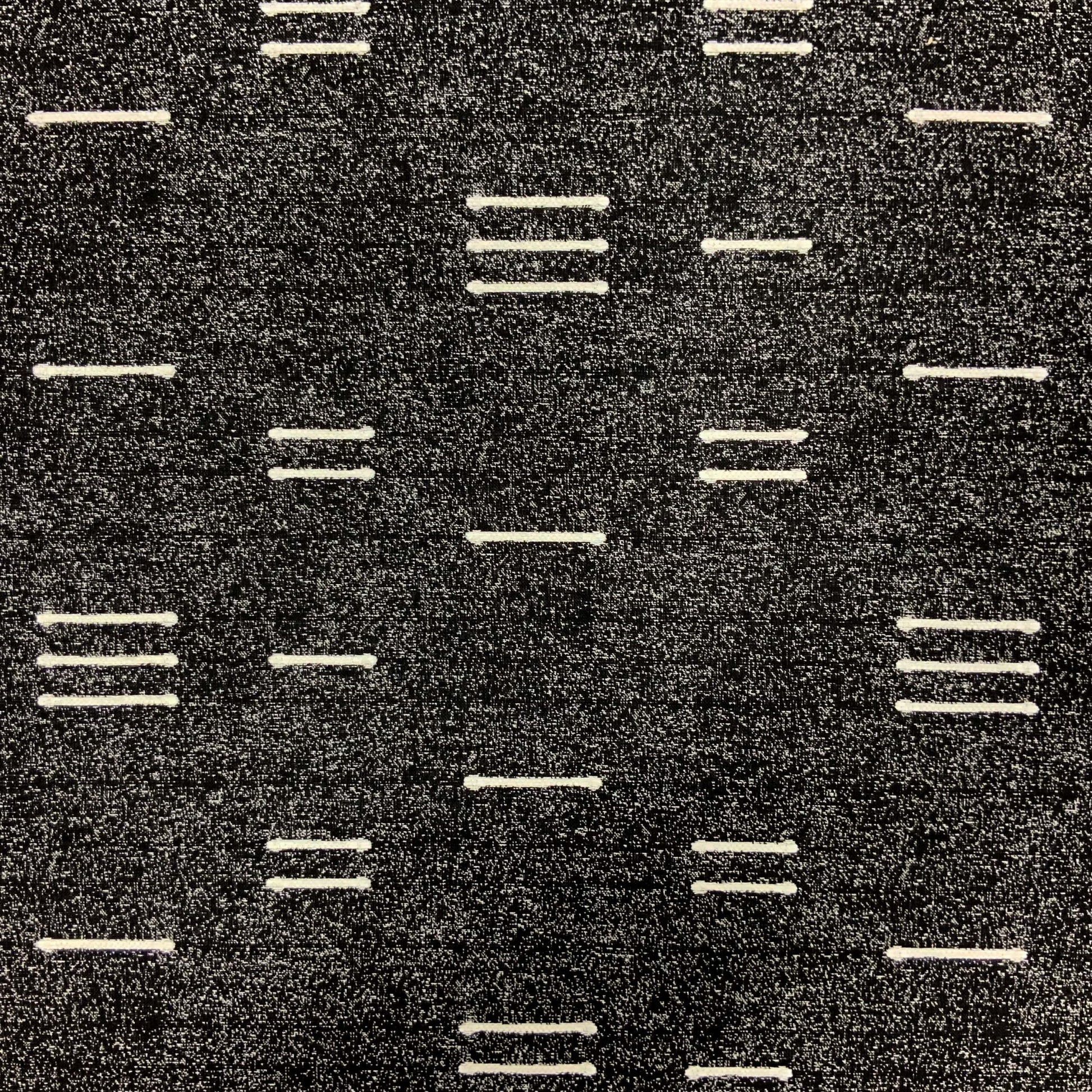 Dark charcoal woven jacquard fabric with white dashed stripes in a minimalist geometric pattern.