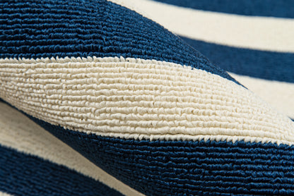 Close-up of navy blue and white striped woven rug with thick looped texture.