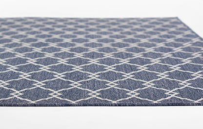 Navy blue flat-weave rug with white diamond lattice pattern; rectangular indoor floor decor
