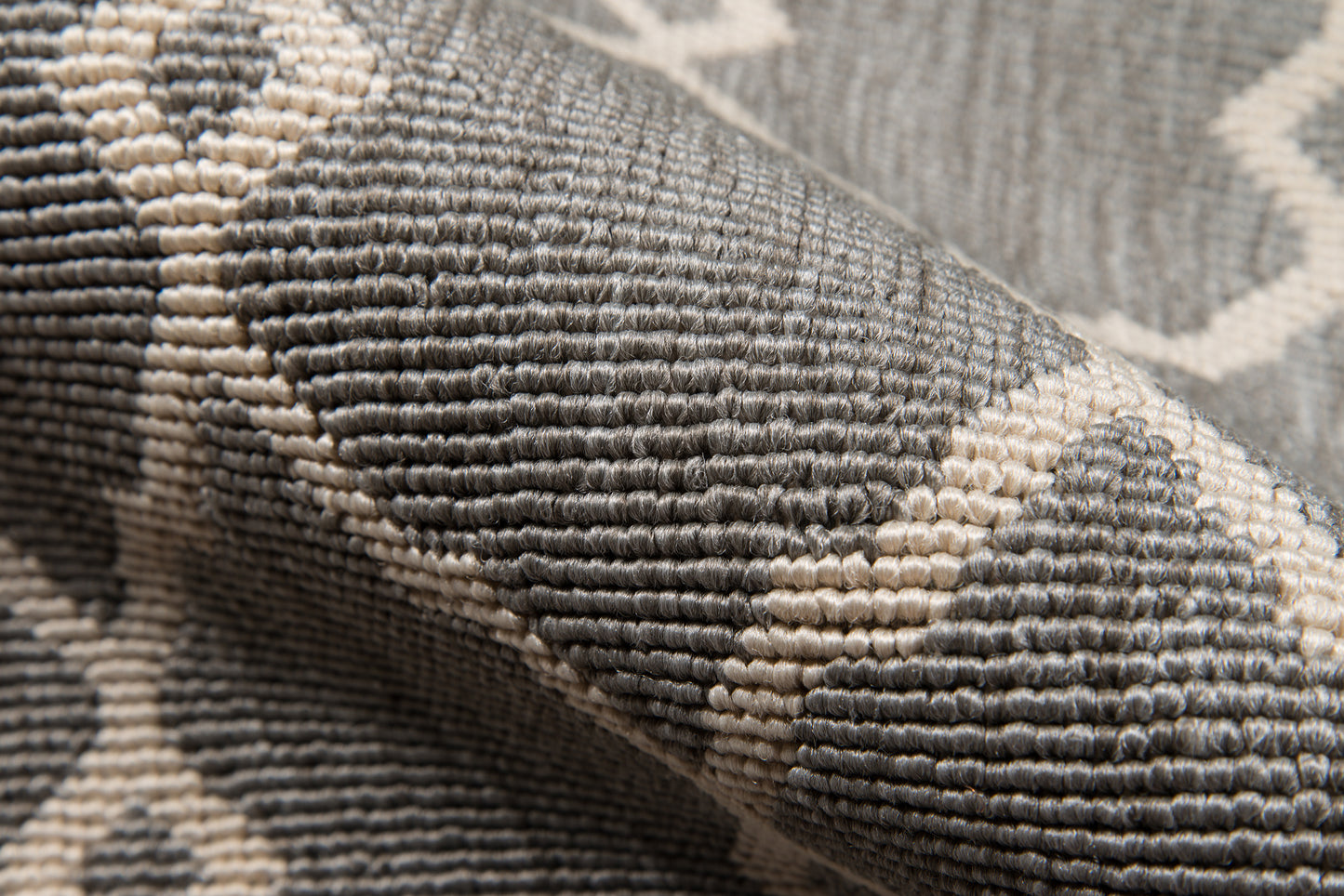 5' x 8' gray and ivory tufted rug with a geometric lattice pattern and woven texture.