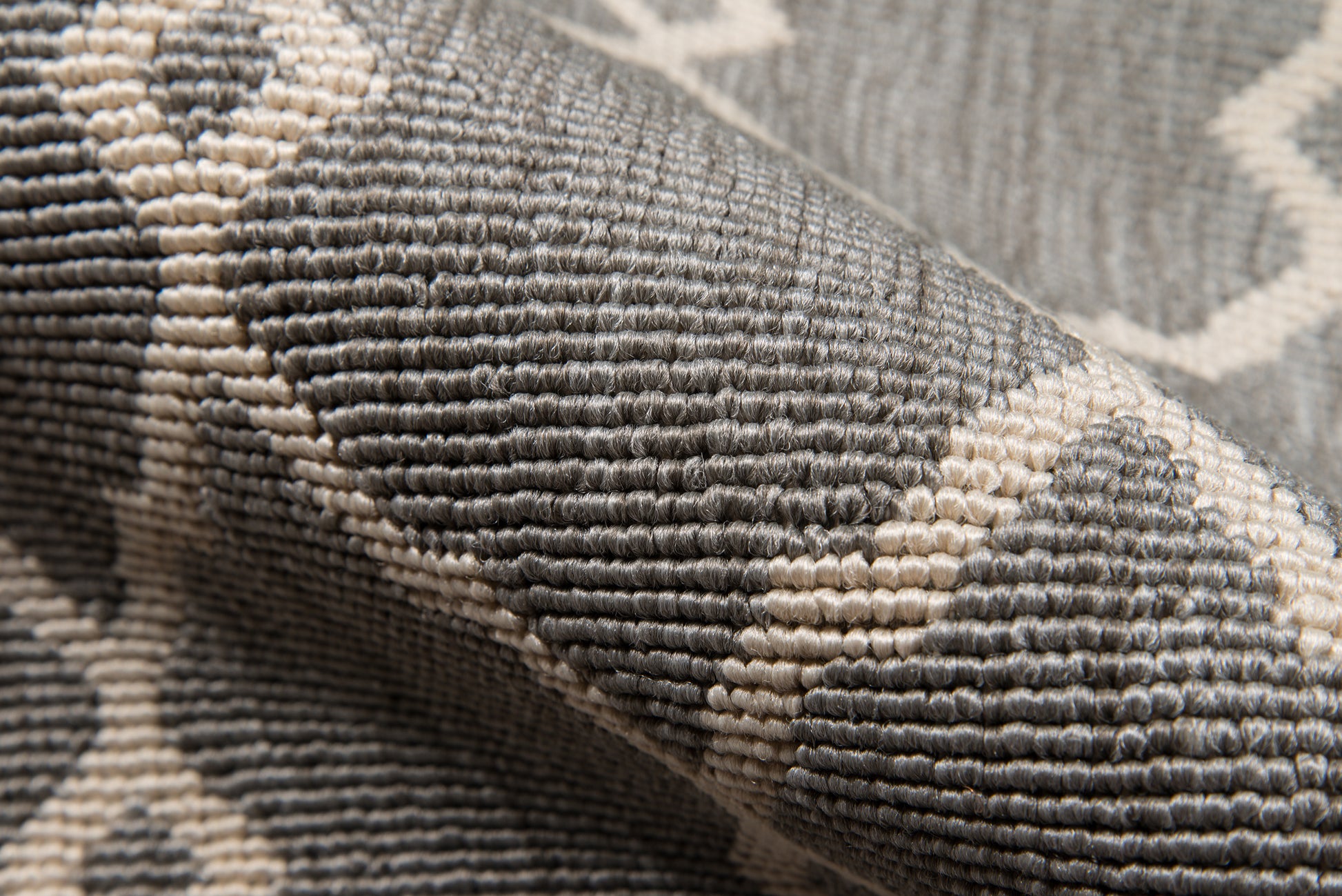 5' x 8' gray and ivory tufted rug with a geometric lattice pattern and woven texture.