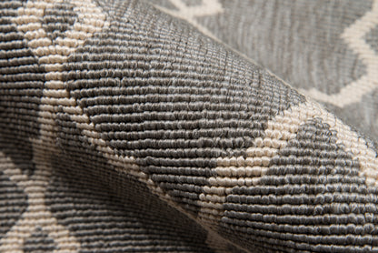 5' x 8' gray and ivory tufted rug with a geometric lattice pattern and woven texture.