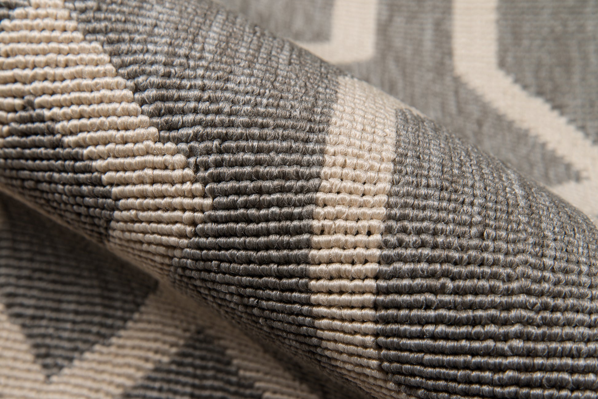 Gray and beige geometric woven rug with textured loop pile; versatile living room or hallway accent.