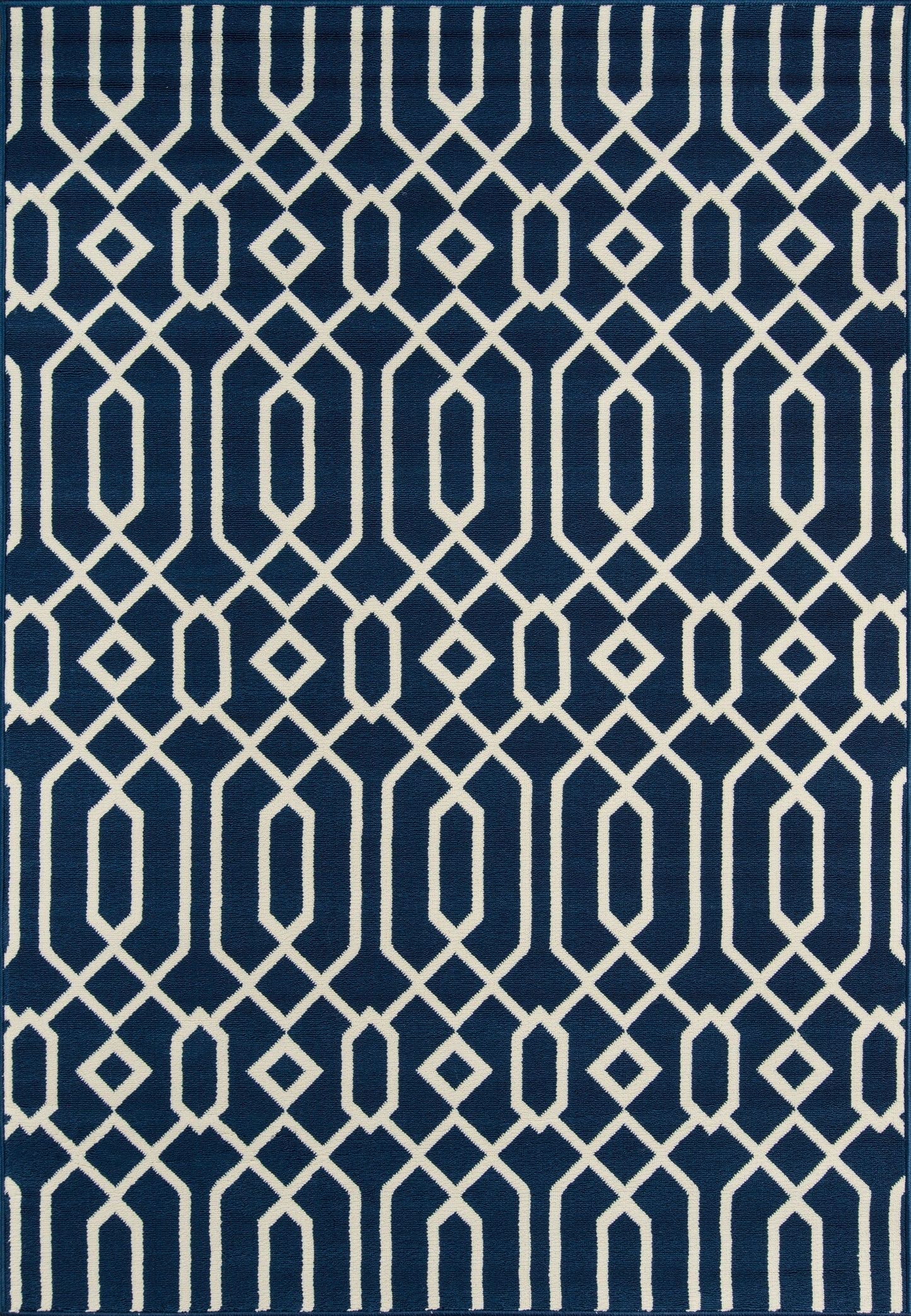 Navy blue area rug with white interlocking diamond lattice pattern, modern geometric style.