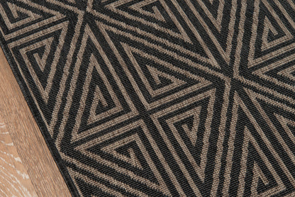 Geometric black-and-beige rug with triangular maze pattern.