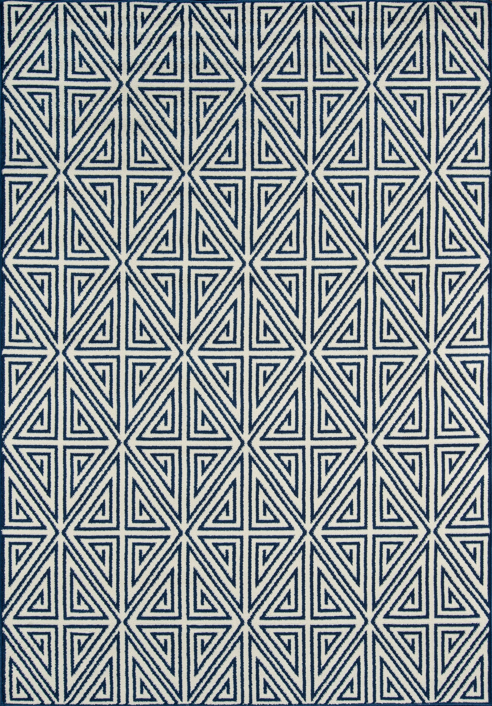 Navy blue rug with a white nested-triangle geometric pattern in a repeating grid.