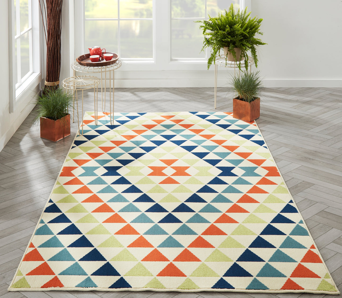 Baja geometric triangle rug in orange, teal, navy & lime on cream; rectangular, modern Southwestern style.