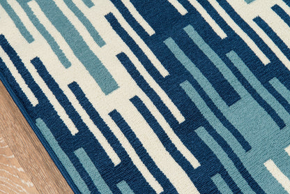 Geometric area rug in cream with navy and teal rectangular bars; modern woven abstract pattern, 8' x 11'.