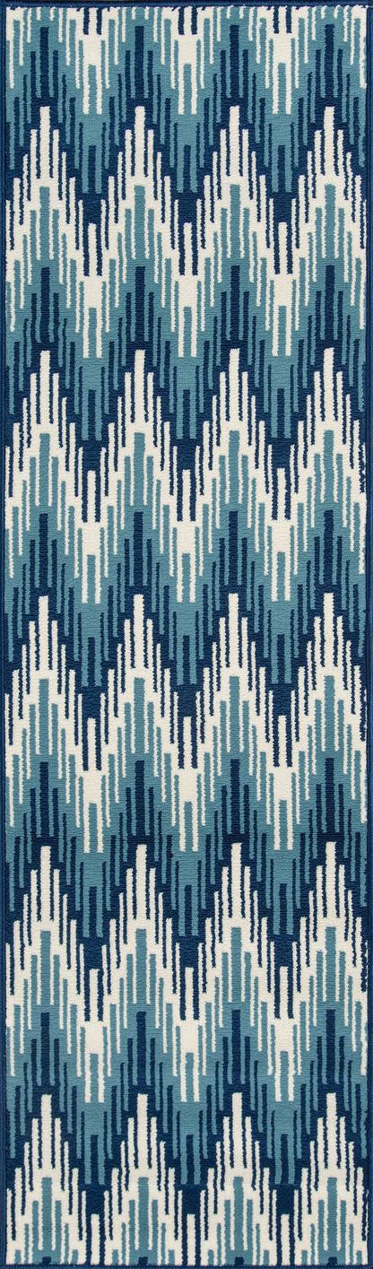 Blue geometric ikat-style rug with navy, teal, light blue and white zigzag blocks; bordered in dark navy.