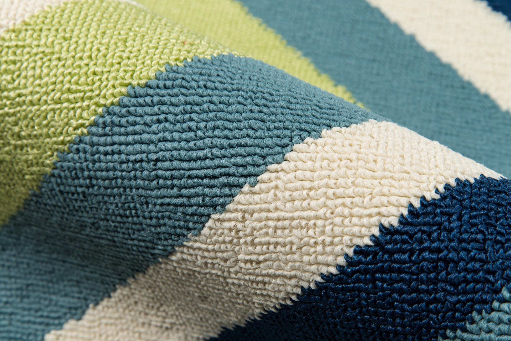Striped, tufted rug with thick looped pile in lime, teal, cream & navy.