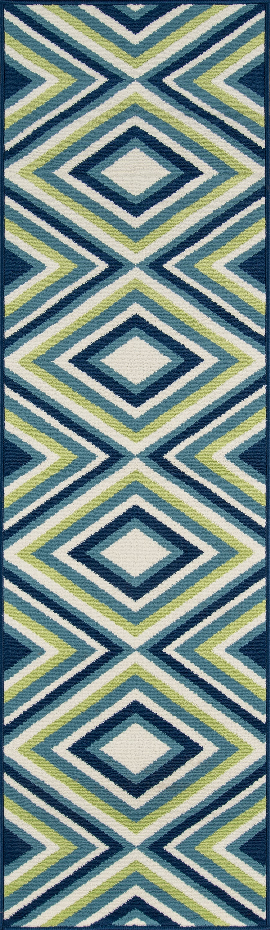 Geometric diamond-pattern area rug in teal, navy, lime green and white; bold coastal modern style.