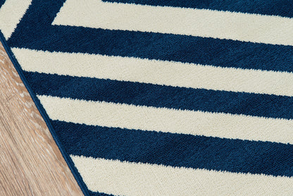 Navy and cream striped rug with thick boucle pile, diagonal view on wooden floor.