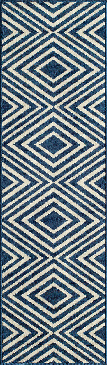 Navy blue and ivory geometric rug with concentric diamond pattern; modern coastal decor.