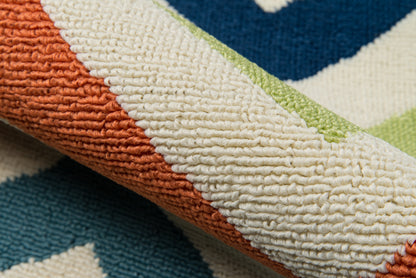 Close-up of a textured striped rug in orange, cream, teal and lime green; looped pile.