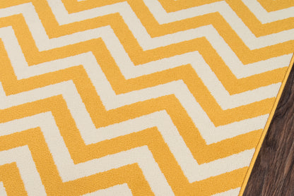 Bright yellow and ivory chevron rug with zigzag pattern on wood floor.