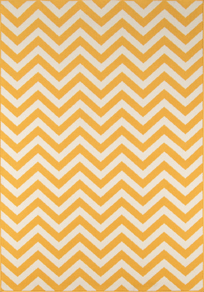 Mustard-yellow rug with white chevron zigzag pattern; bold geometric decor accent.