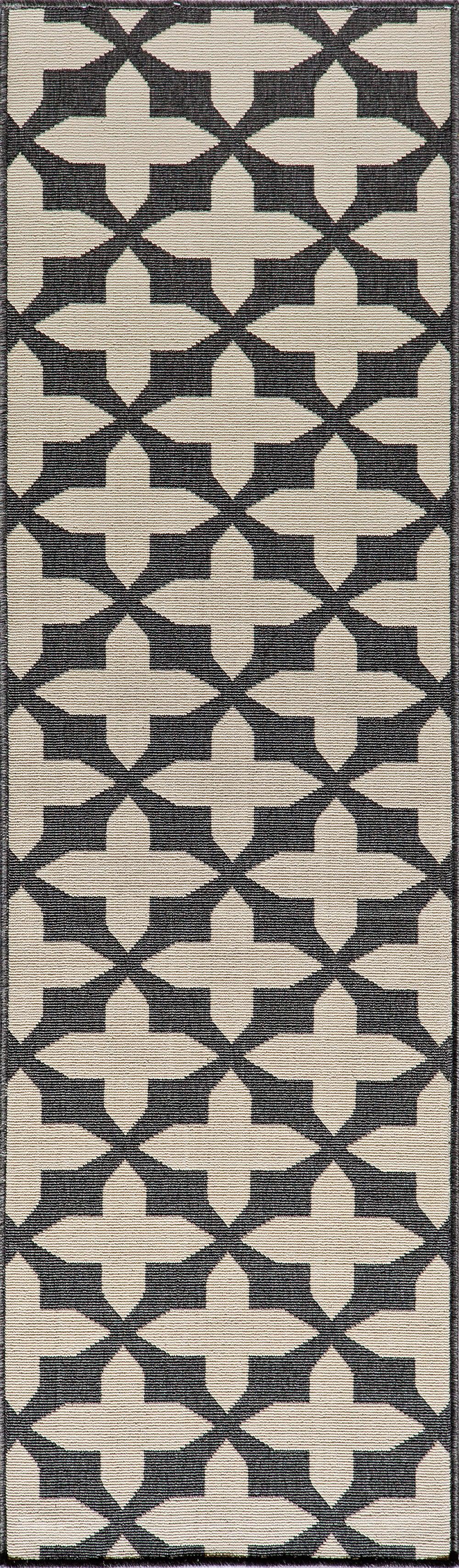 Narrow geometric rug with beige cross motifs on dark background; woven lattice pattern.