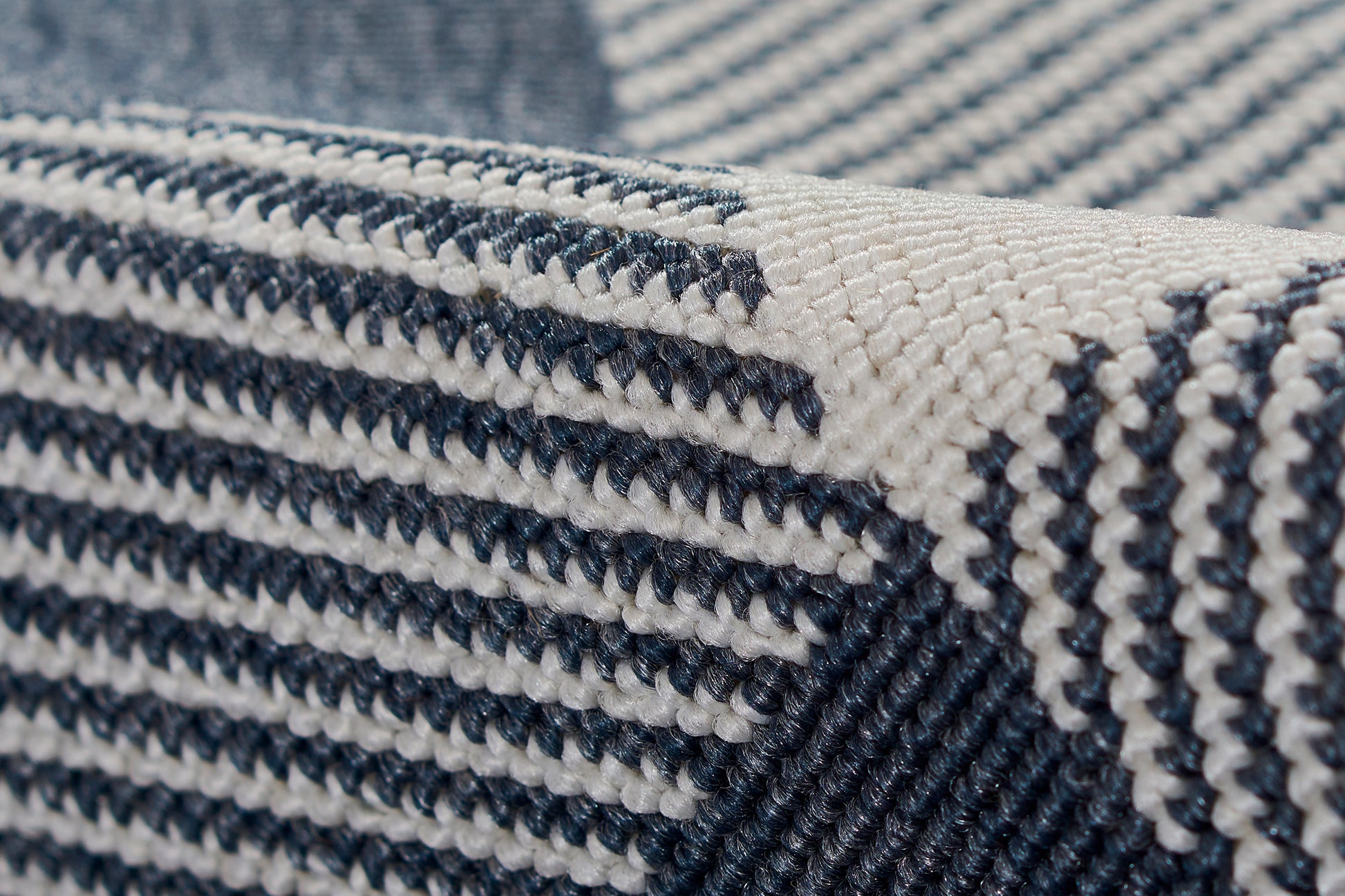 Close-up of navy and white striped rug with a chunky, woven texture; 8' x 11'.