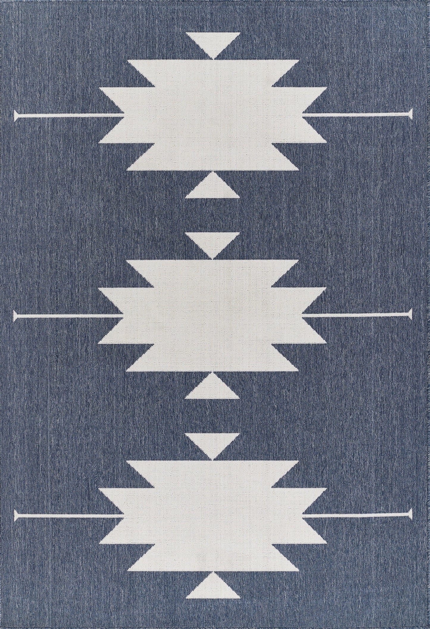 Denim-blue rug with three large white starburst shapes and small triangles, arranged in a vertical pattern.