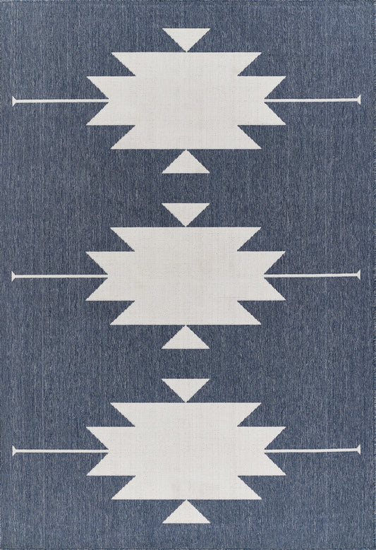 Denim-blue rug with three large white starburst shapes and small triangles, arranged in a vertical pattern.