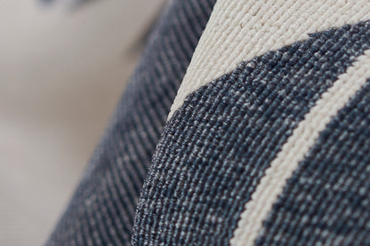 Close-up of dark blue denim with a cream stripe, textured twill weave, ideal for cushions or upholstery.
