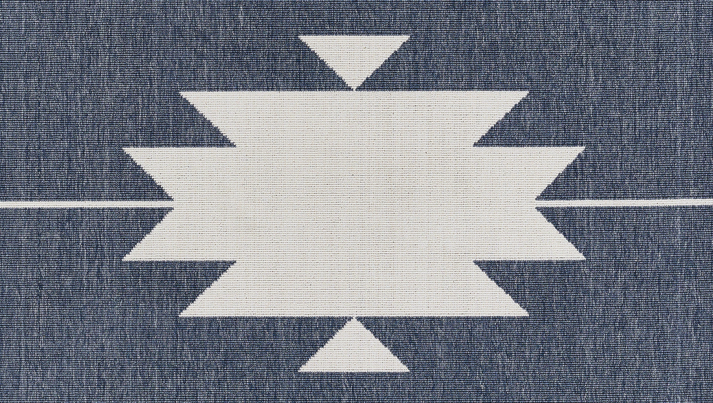White geometric starburst motif on dark blue denim fabric; central zigzag rectangle with pointy sides.