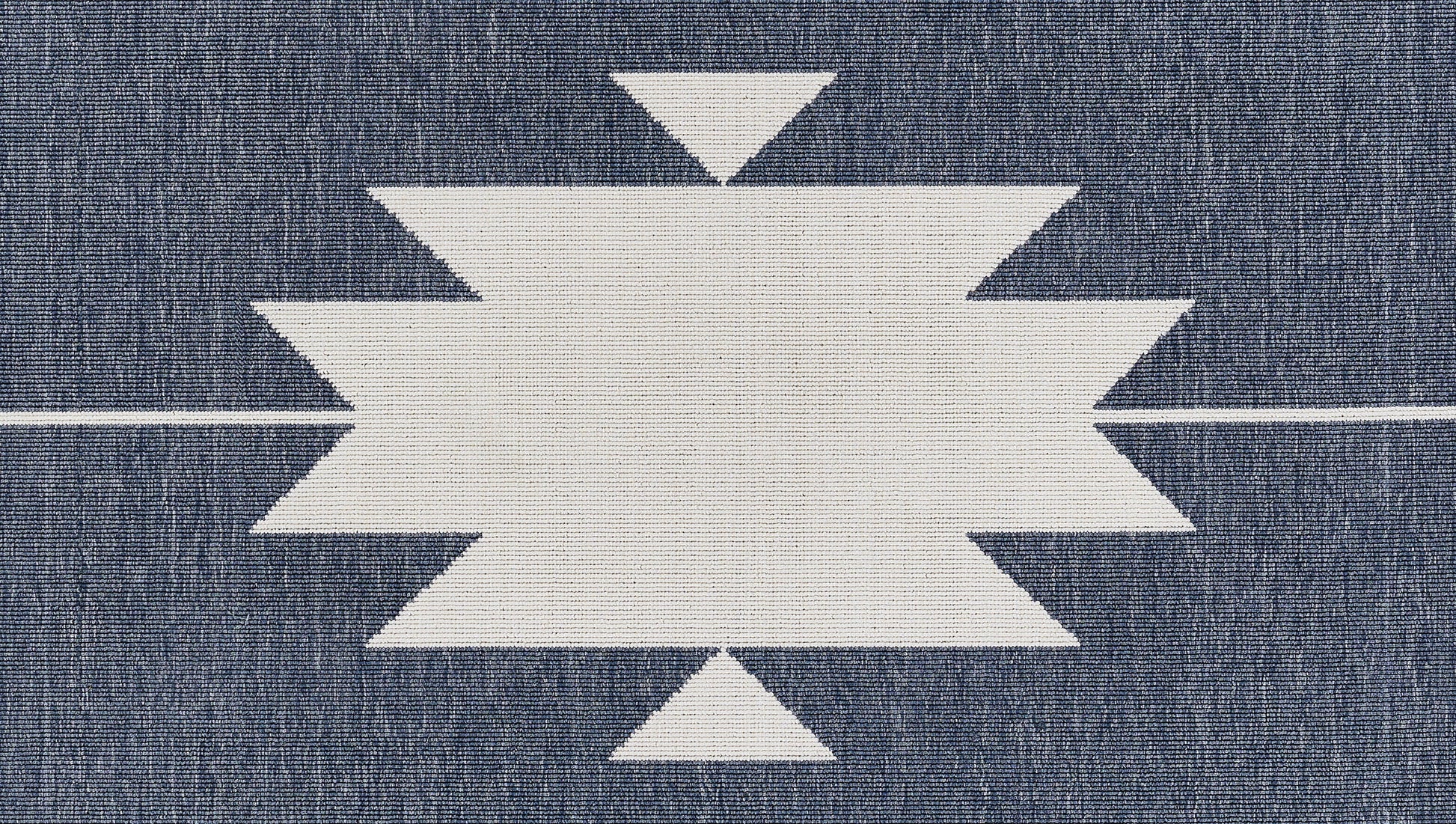 White geometric starburst motif on dark blue denim fabric; central zigzag rectangle with pointy sides.