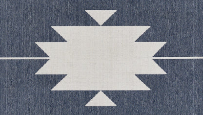 White geometric starburst motif on dark blue denim fabric; central zigzag rectangle with pointy sides.