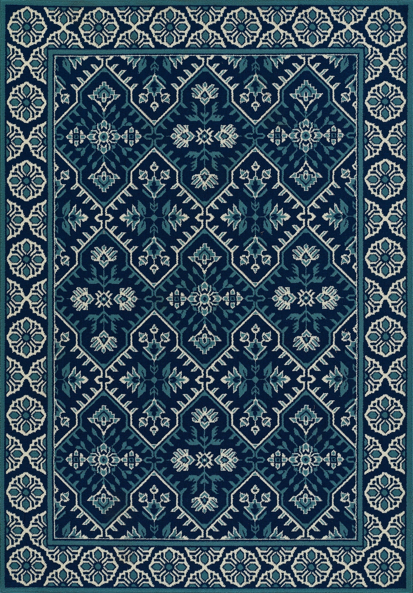 Rectangular teal rug with navy and ivory geometric diamond lattice, floral motifs and an ivory patterned border.