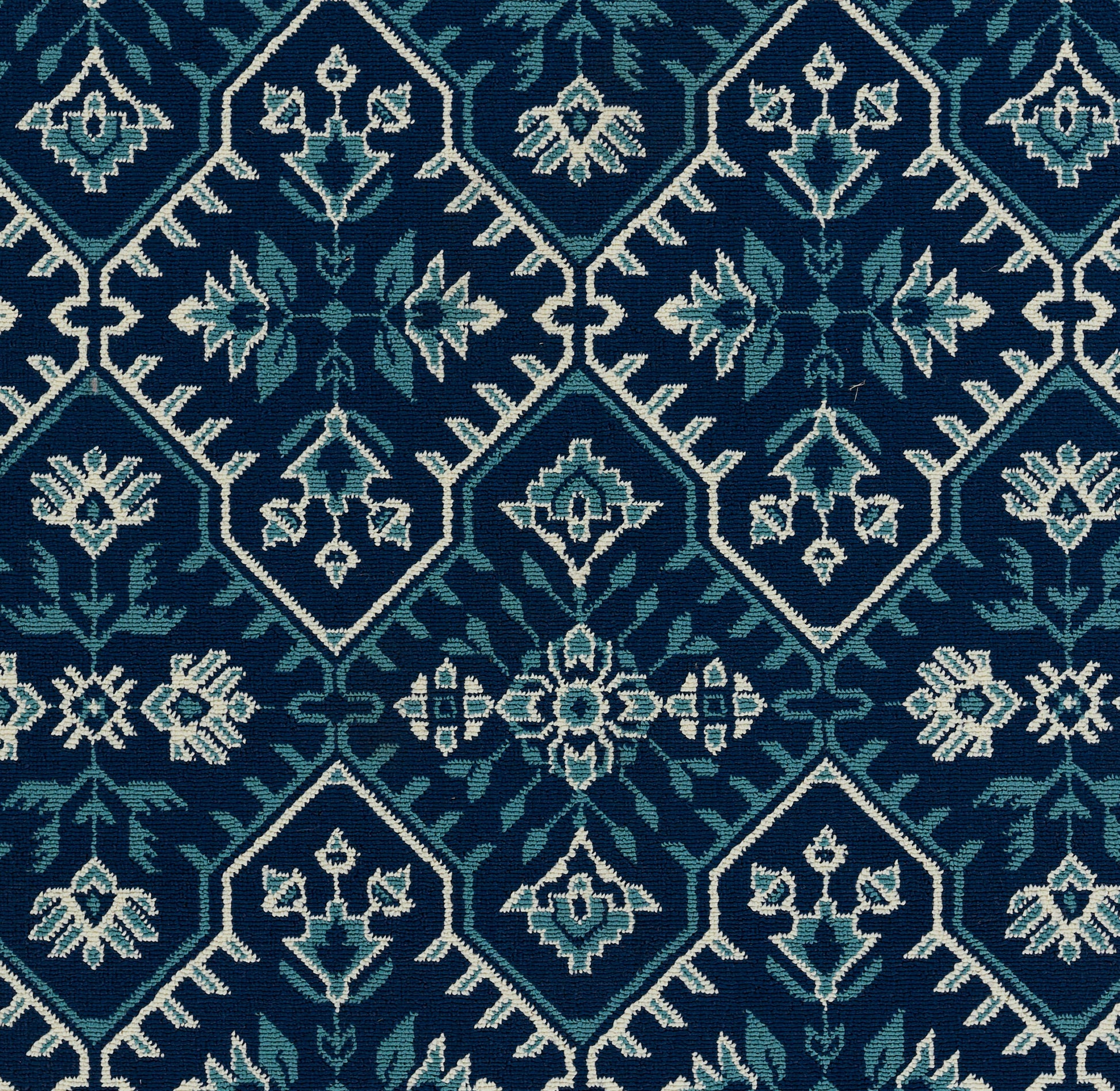 Teal and navy geometric rug with diamond medallions and floral accents, 9' x 13'.