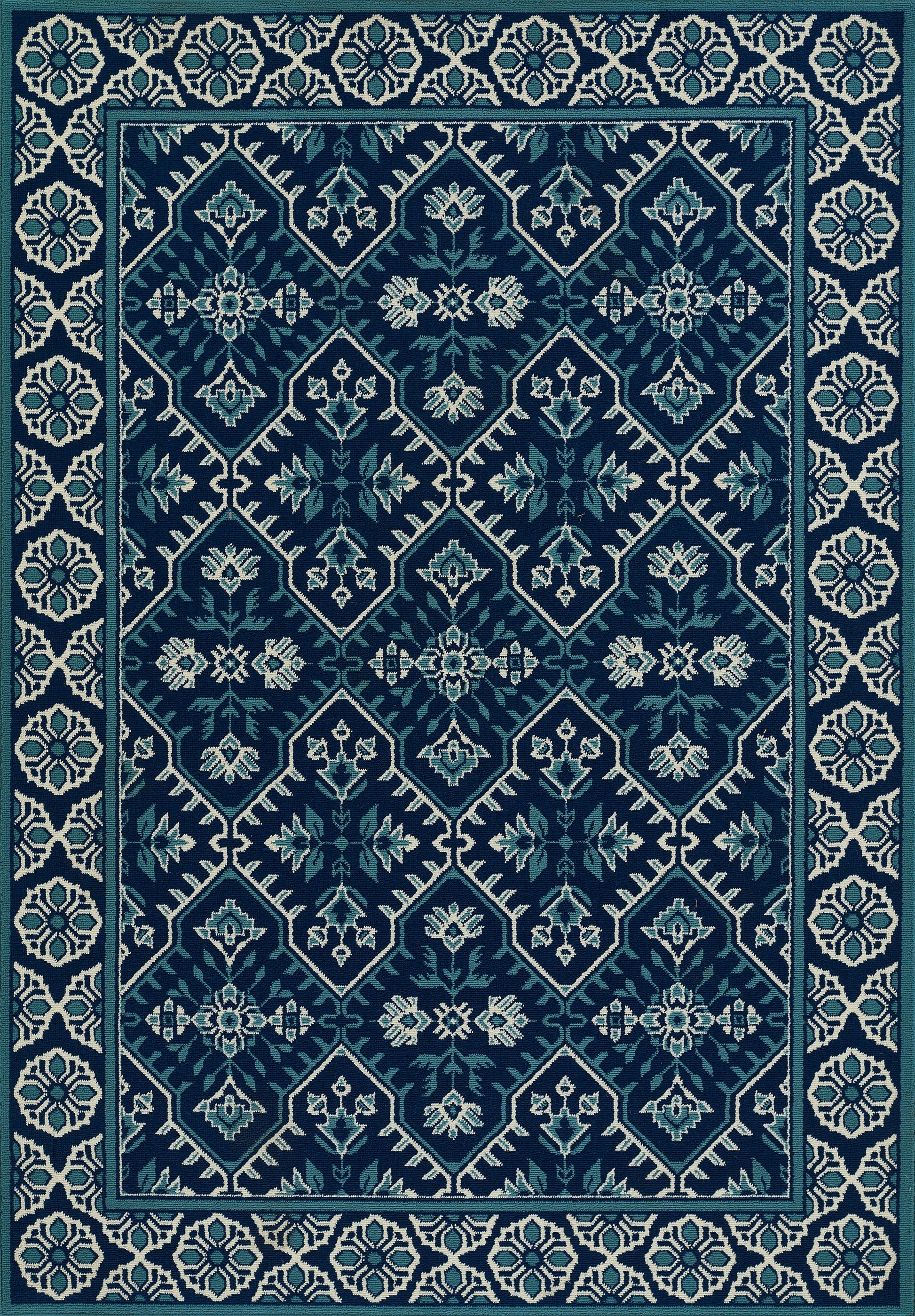 Teal and navy rug with diamond lattice and floral motifs, framed by a cream geometric border.