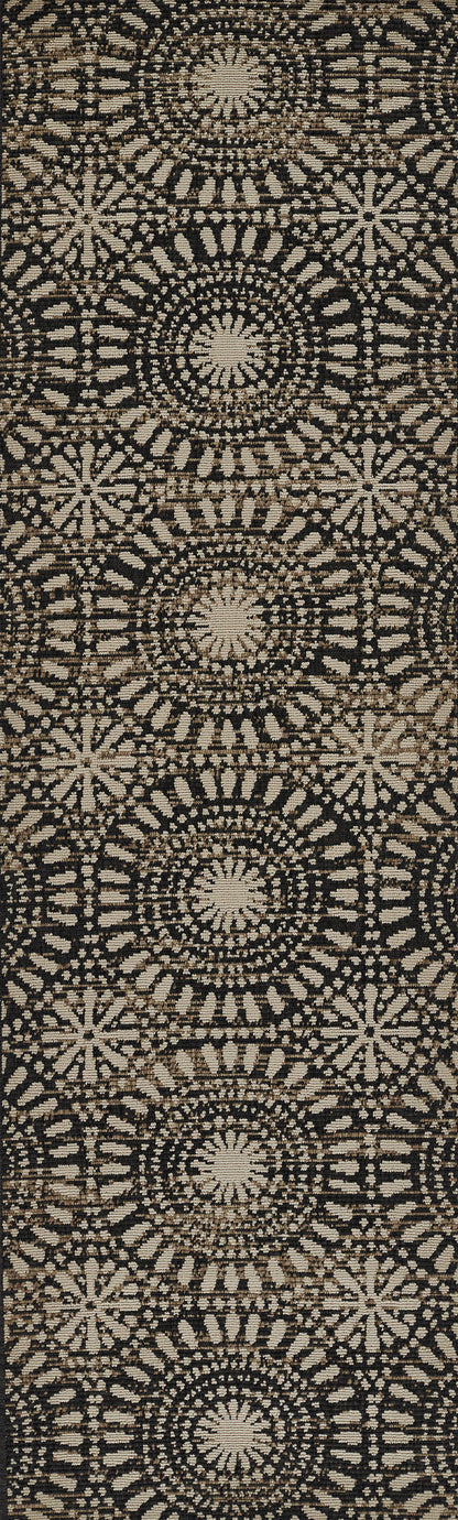 Beige circular mandala rosette pattern on black woven fabric rug & repeating boho motif.