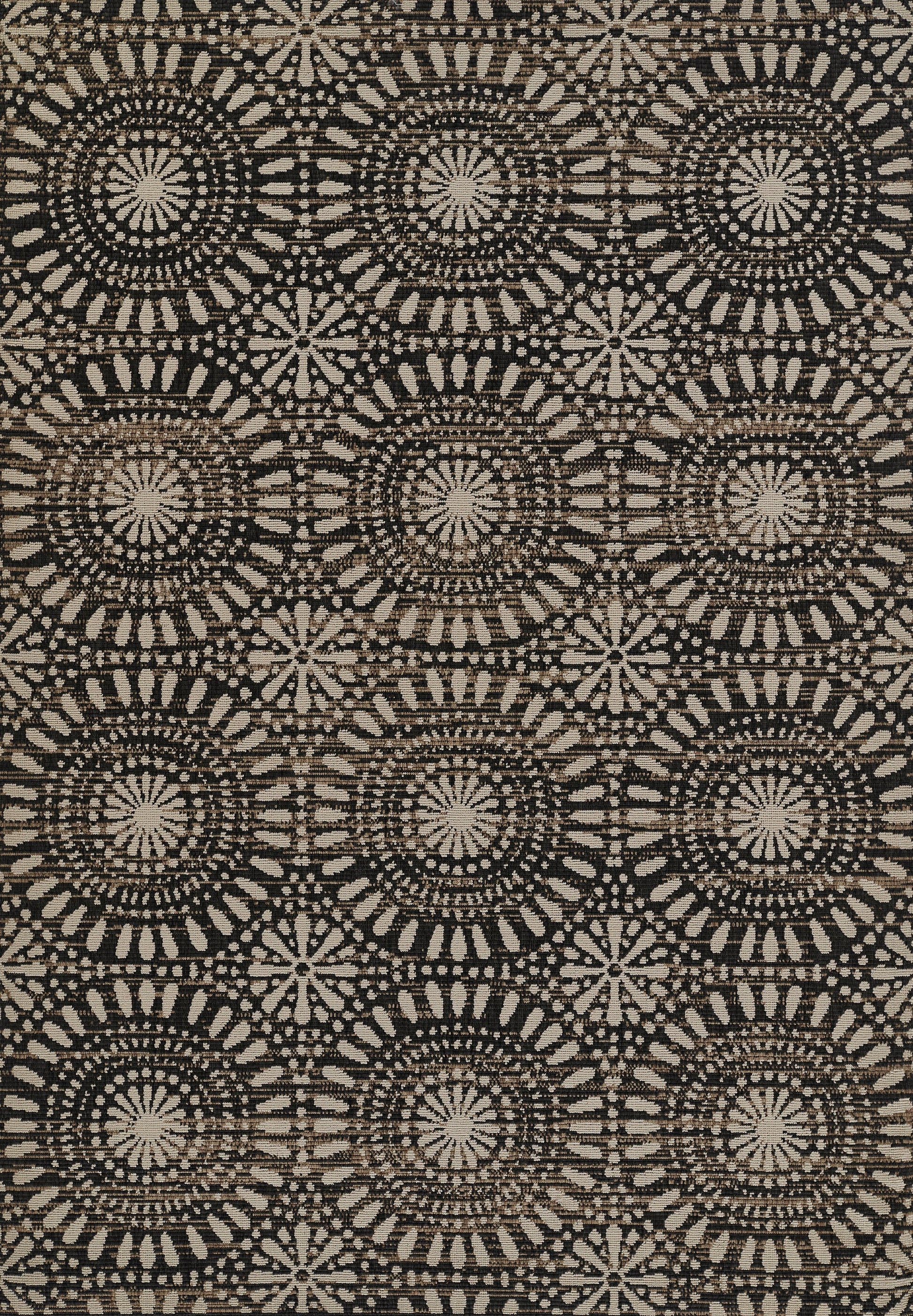 Beige and black woven textile with repeating circular sunburst medallions.