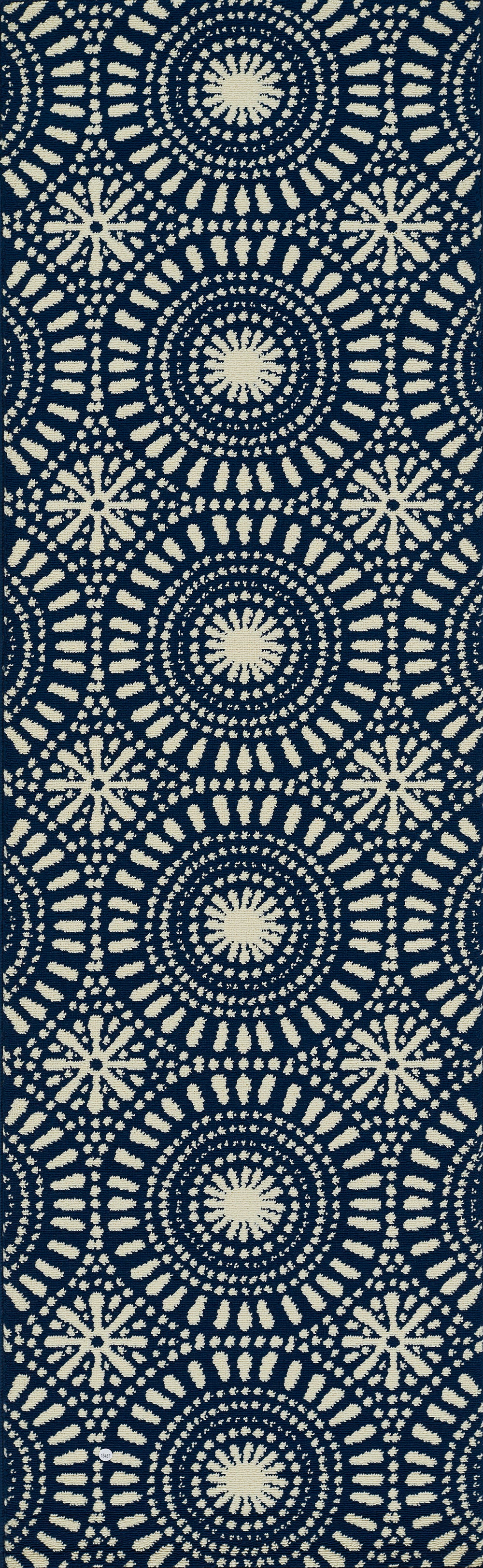 Navy rug with cream concentric circle dot motifs and starburst accents in a repeating geometric print.