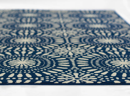 Navy blue woven rug with ivory circular floral medallion patterns and geometric repeating motif.