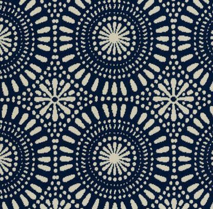 Navy fabric with ivory circular tie-dye mandala pattern, repeating boho motif.