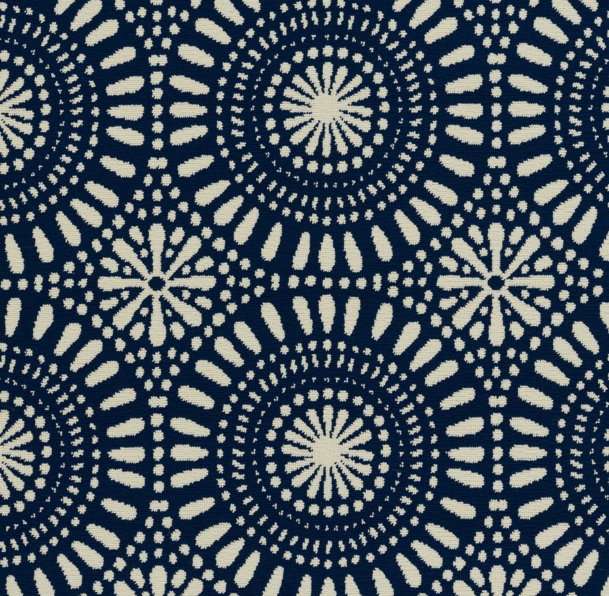 Navy rug with cream circular mandala pattern of radiating dots; repeating bold geometric print.