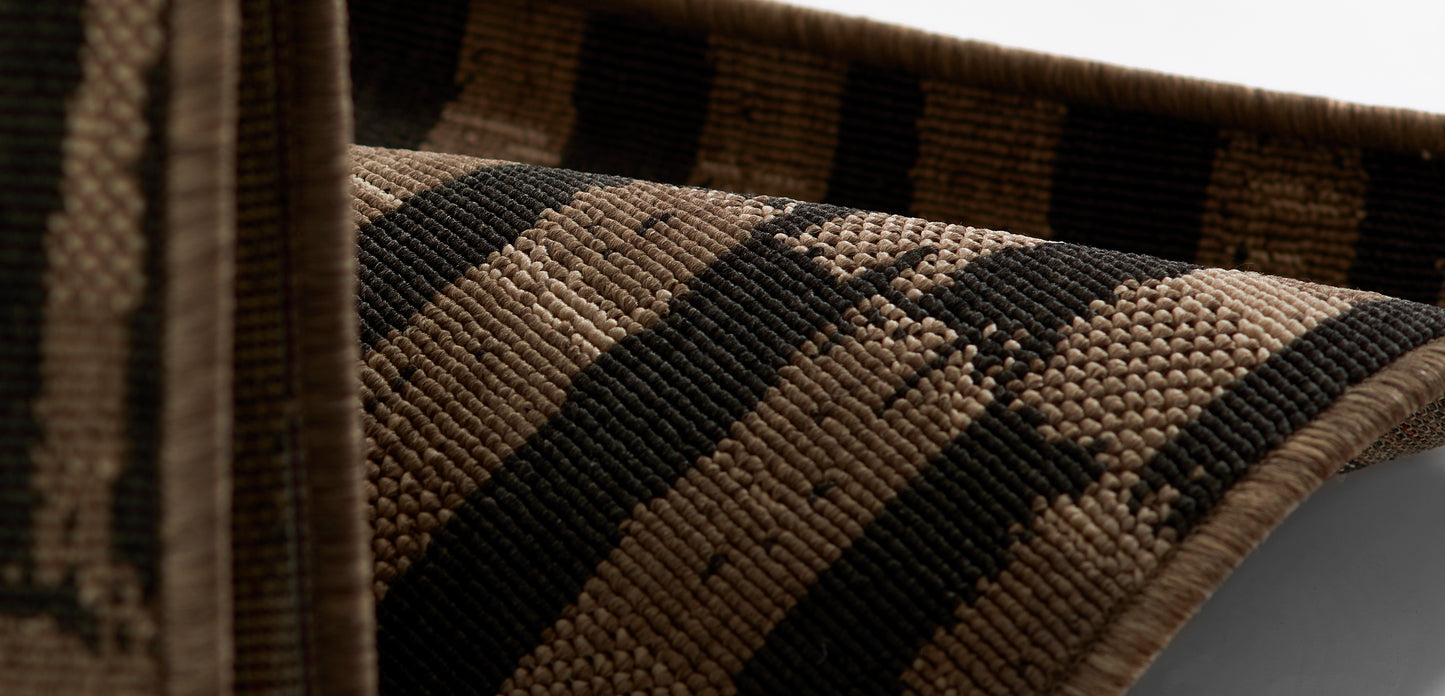 Woven rug with dark brown and beige stripes; coarse rustic jute/sisal texture.