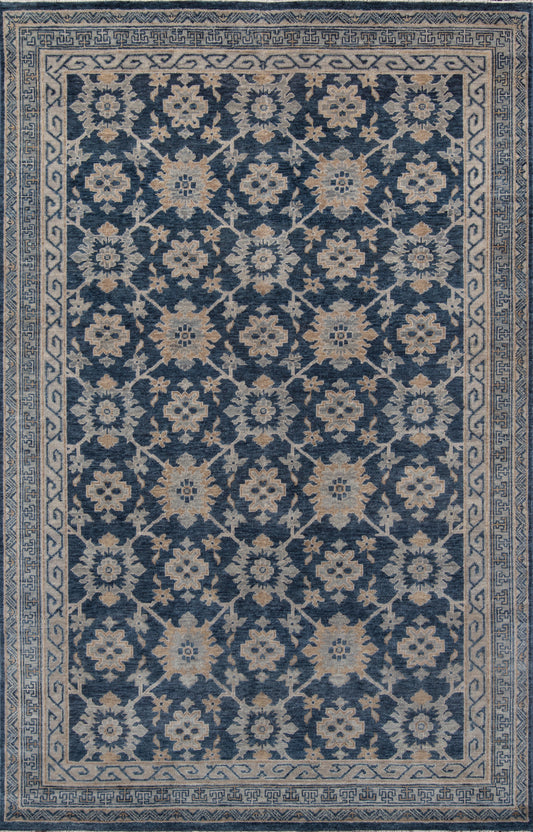 Blue woven oriental rug with cream blossoms and vines; beige border with Greek-key motif.
